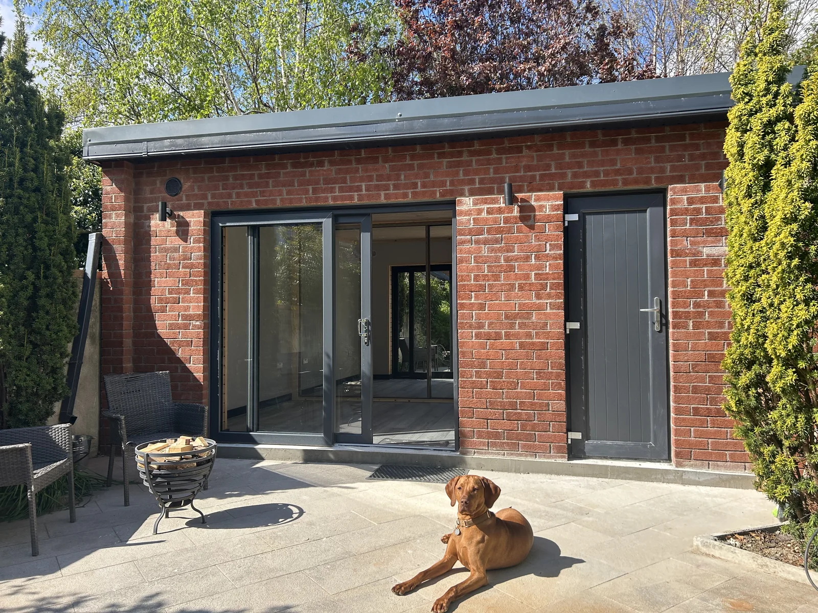 Garden room exterior with brick finish and aluminium sliding doors