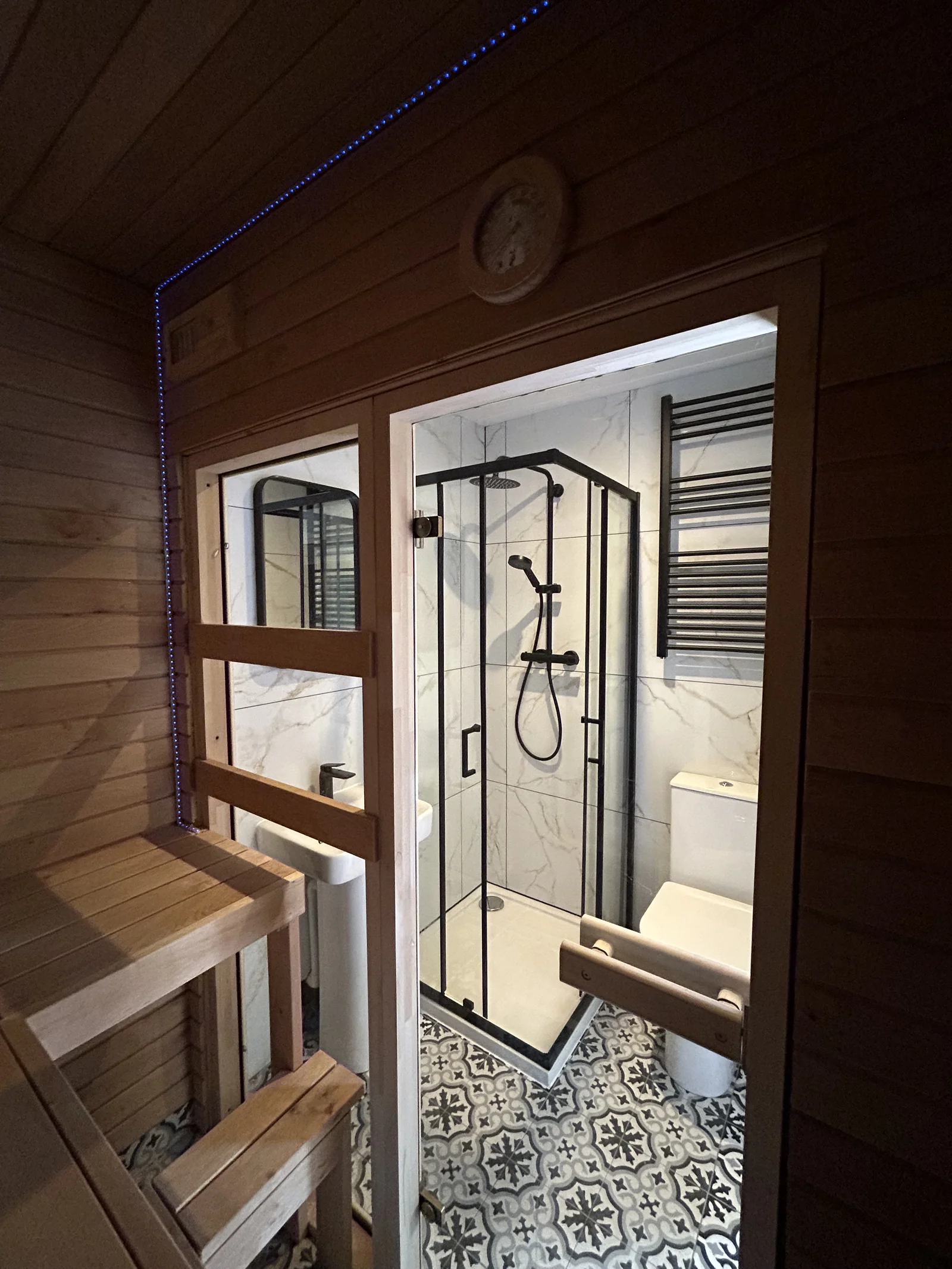 Black alder timber sauna with view through to bathroom